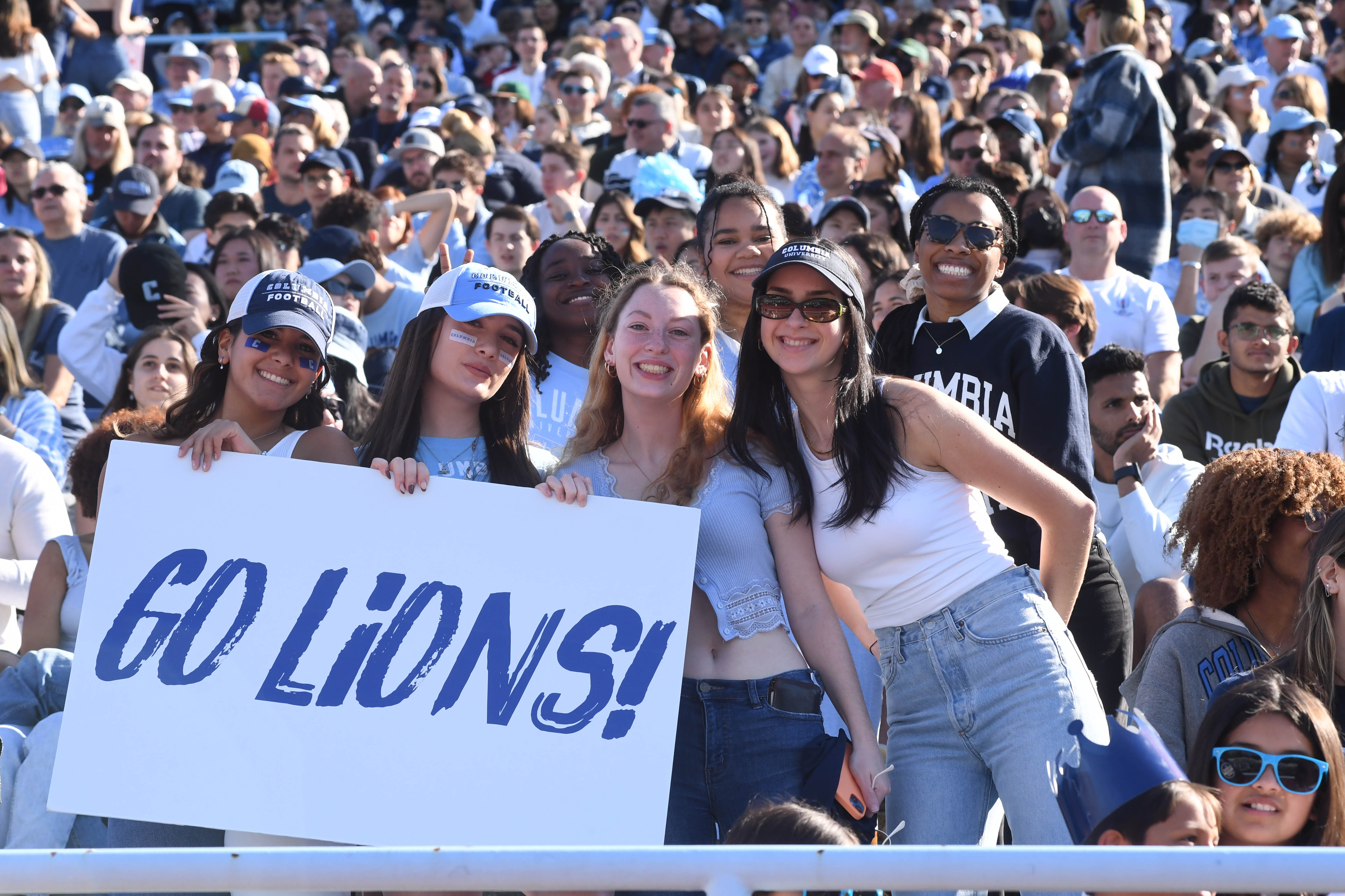 Students in the crowd at the Homecoming football game.