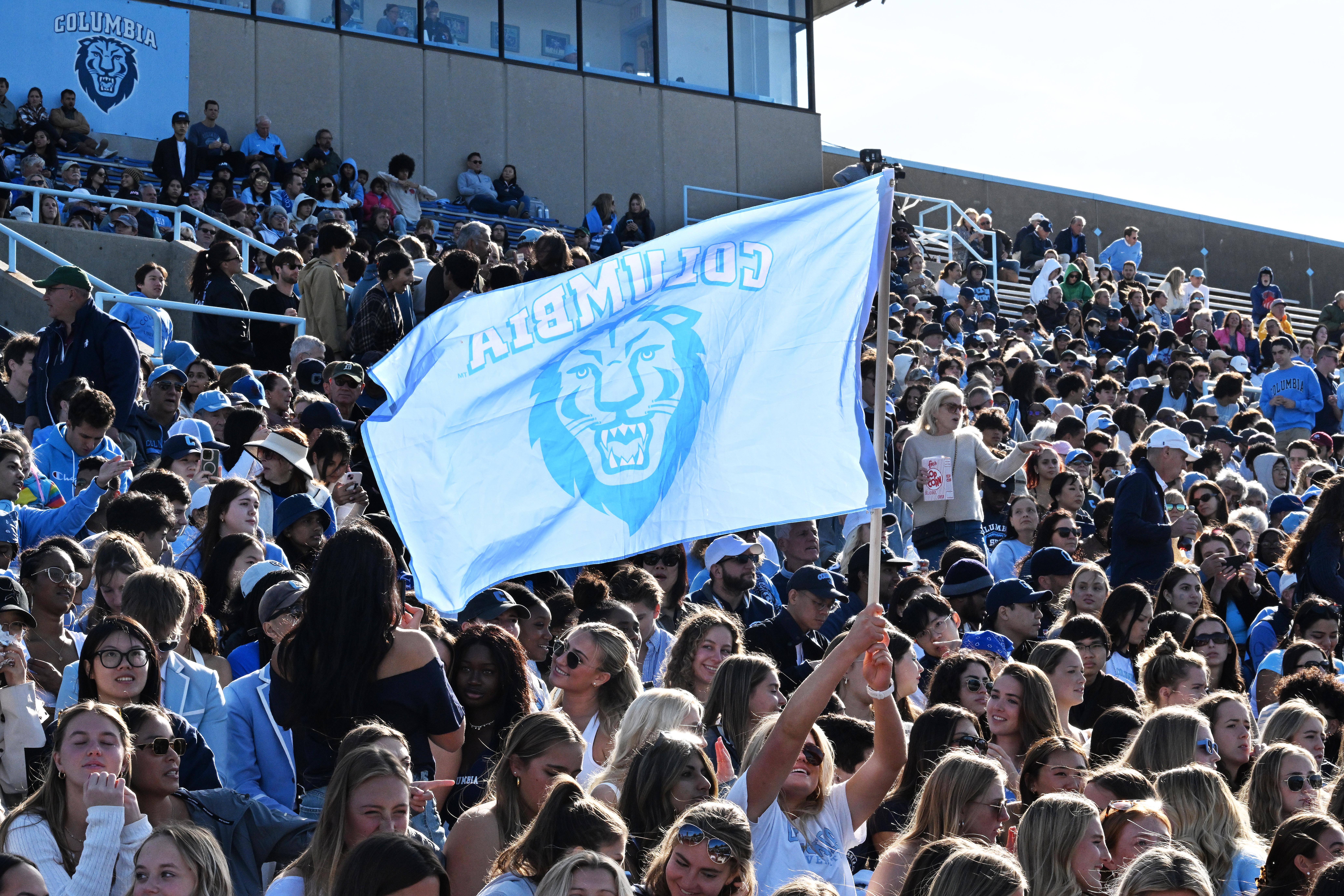 Students in the crowd at the Homecoming football game.