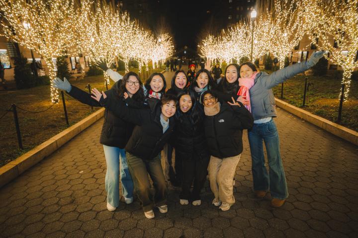 Students taking pictures at the College walk Tree Lighting.