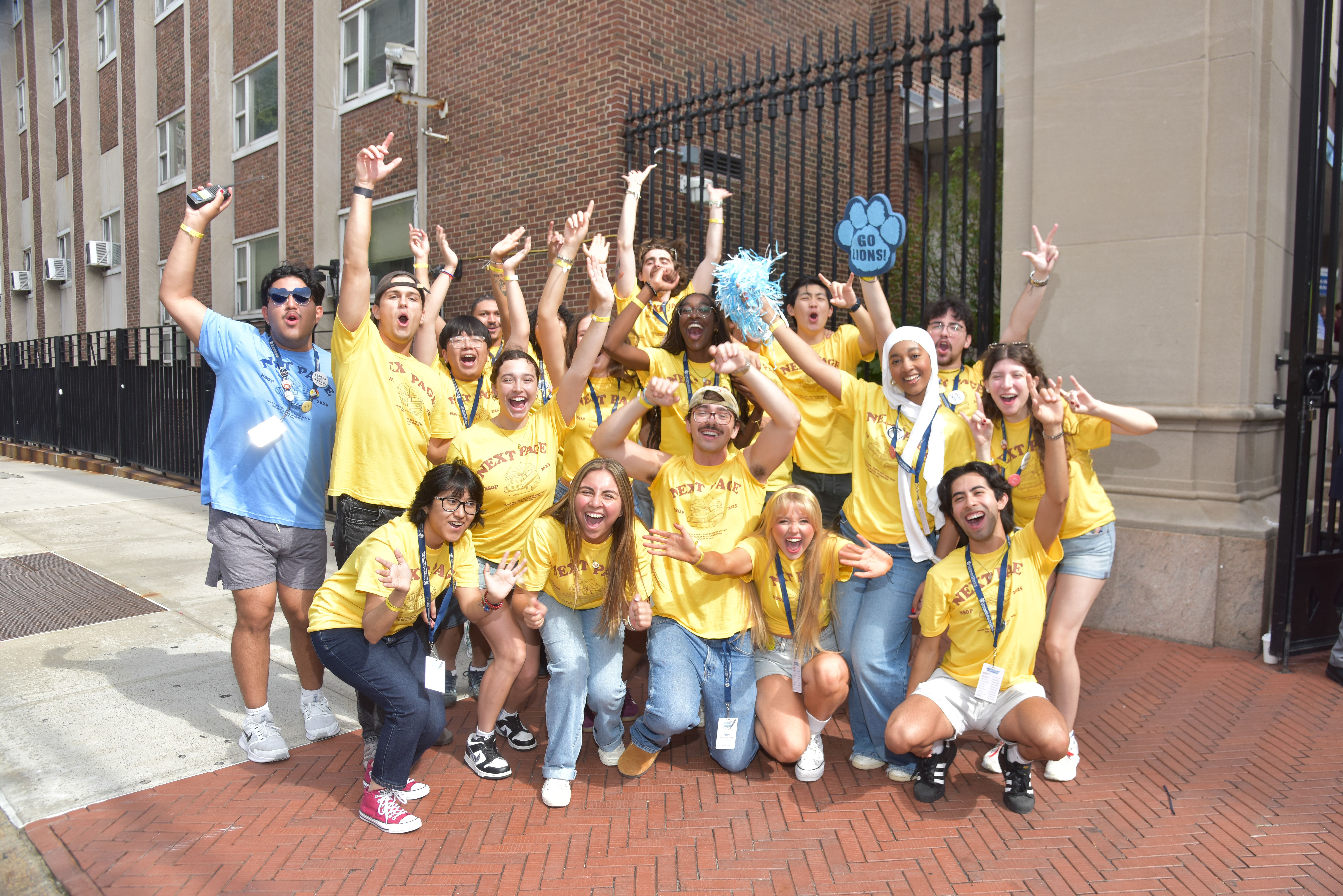 New Student Orientation Program Leaders pose at a giveaway table